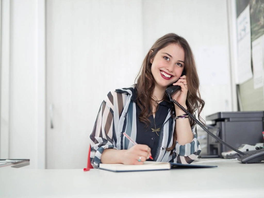 Woman holding telephone to her ear